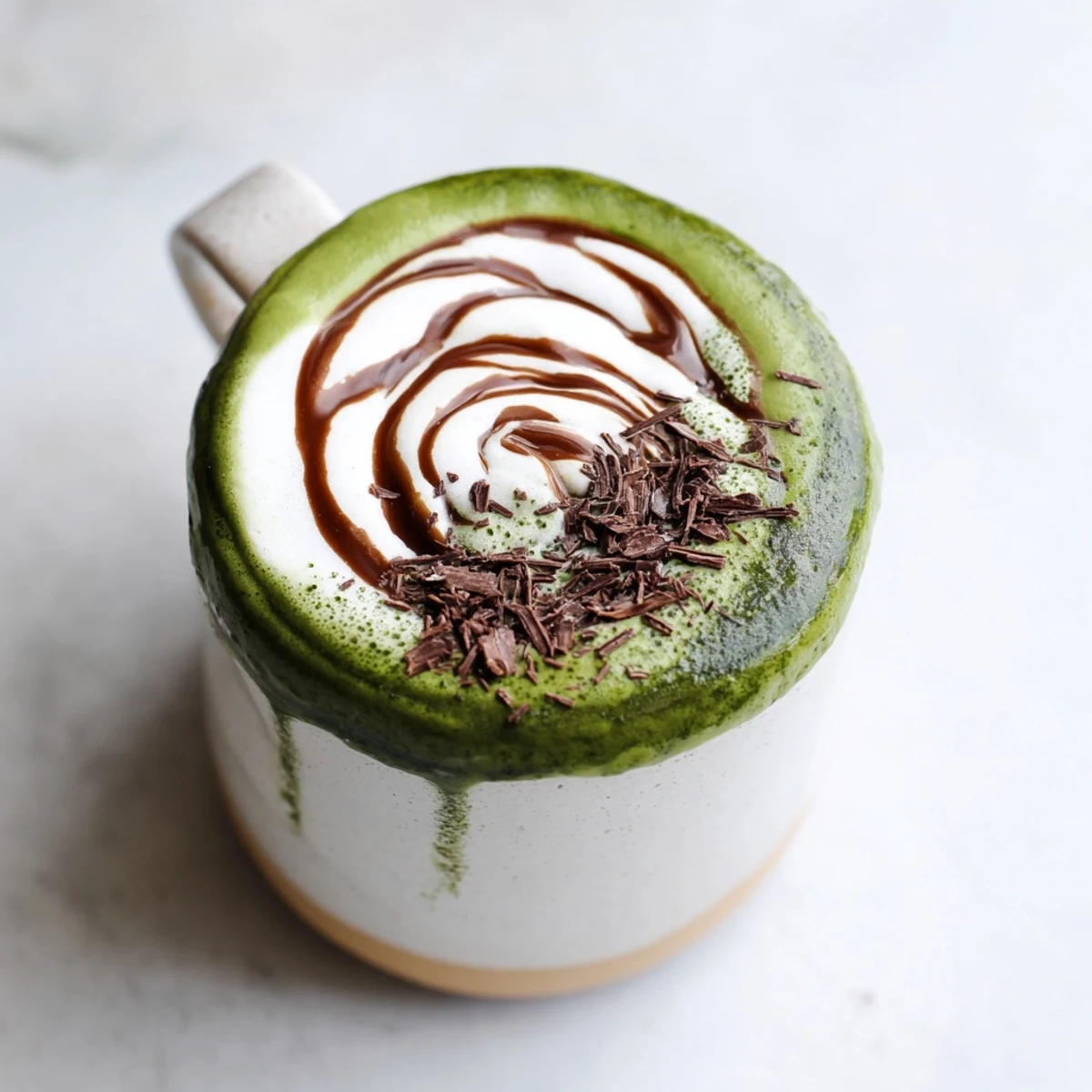 Steaming Matcha Hot Cocoa Protein Mug topped with whipped cream, ready for a cozy treat.