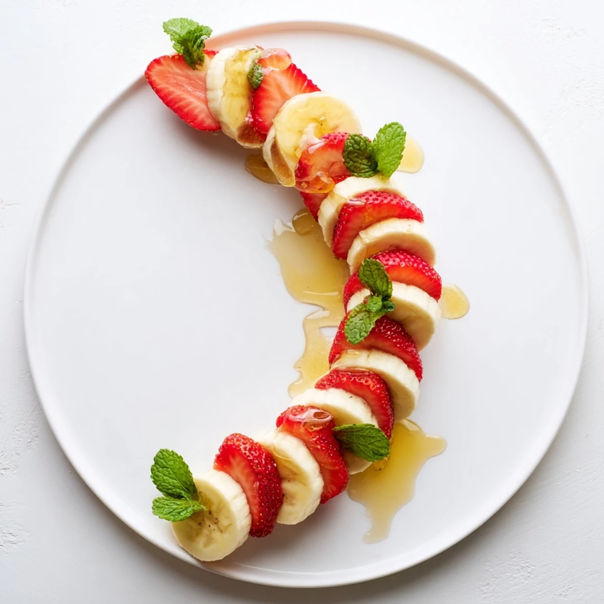 Fresh banana strawberry candy cane arranged on a plate, offering a sweet & festive holiday snack.