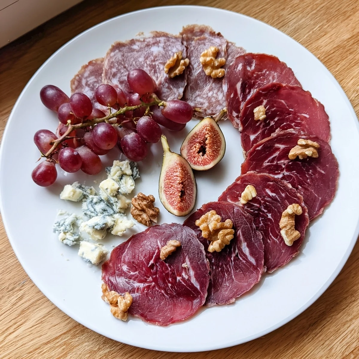 A bountiful Majestic Venison Charcuterie Platter offering cured venison, cheeses, fruits, and crackers for sharing.