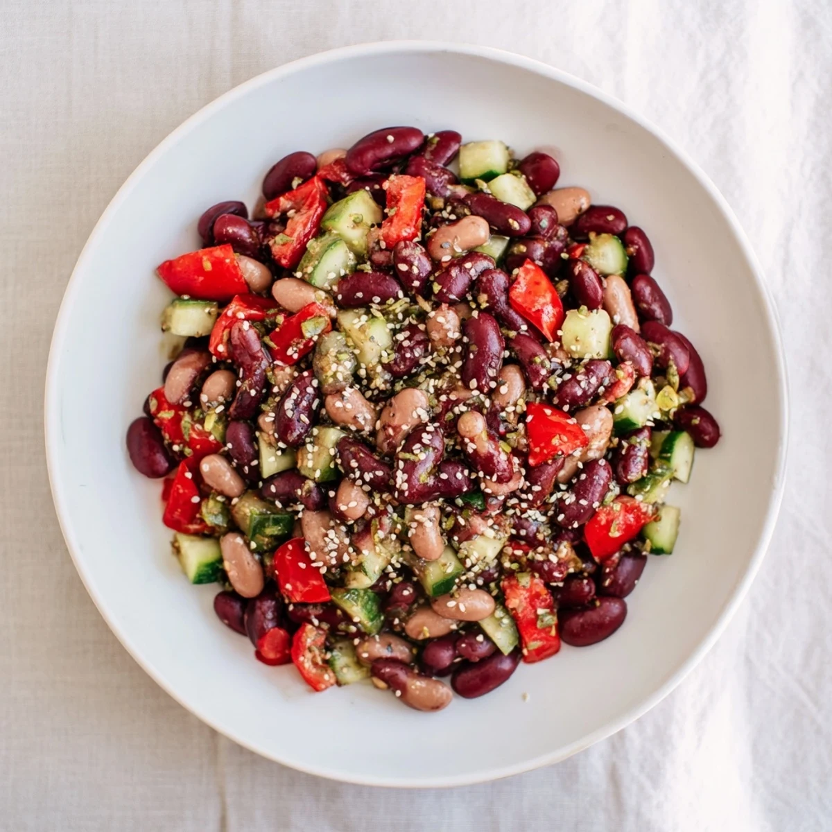 Freshly tossed Dense Bean Salad with visible chia and hemp seeds, ready to serve and enjoy.