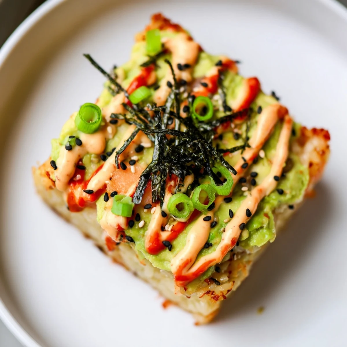 A delightful view of a crispy rice salmon stack, textures of crunchy rice and savory salmon.