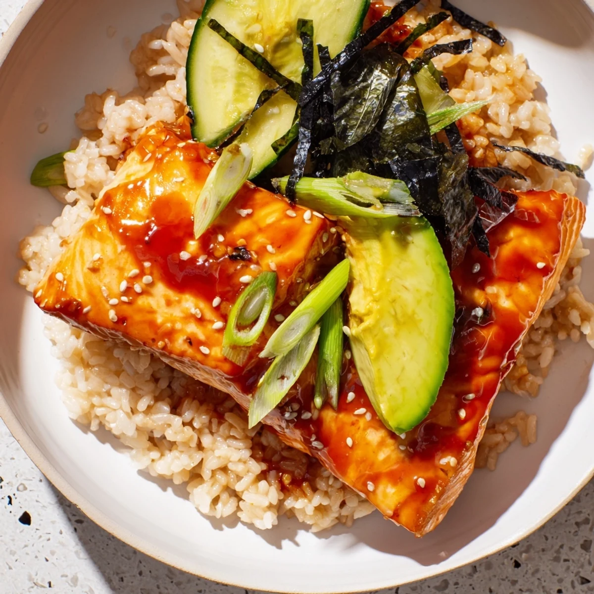 Flavorful Emily Mariko-Inspired Sticky Orange Gochujang Salmon Bowl, featuring tender baked salmon, perfect with fluffy rice.