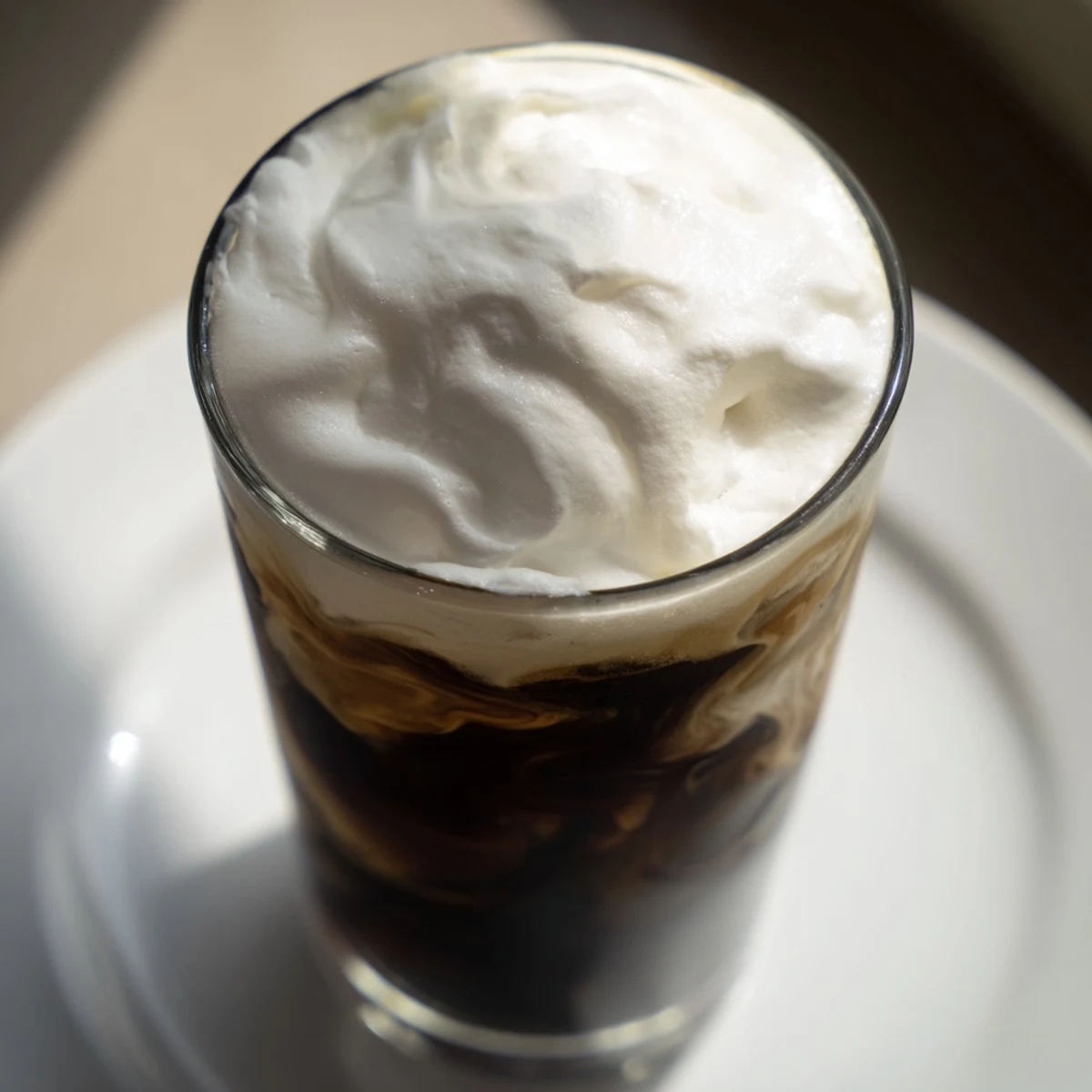 Homemade Starbucks cold foam, a creamy white topping, is perfectly textured and easily spooned.