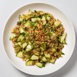 Vibrant Crispy Cucumber Rice Salad features crunchy cucumber and fluffy rice, drizzled with sesame-soy dressing.