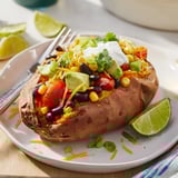 Steaming-hot, vibrant Loaded Baked Sweet Potatoes bursting with black beans and creamy avocado slices.