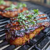 Grilled peach and burrata salad with arugula and balsamic glaze, a colorful summer dish perfect for warm-weather entertaining.  