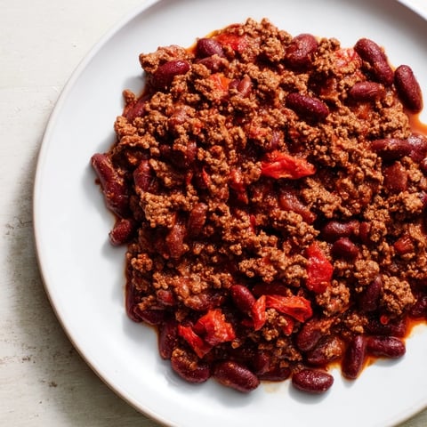 Steaming bowl of Secret 4-Ingredient Slow Cooker Chili, hearty and perfect for a chilly evening with rich flavors.