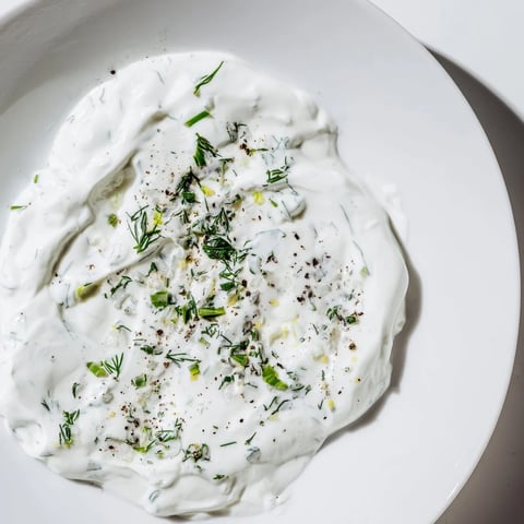 A bowl of creamy Greek Yogurt Ranch Dip, perfect for dipping fresh vegetables or chips.