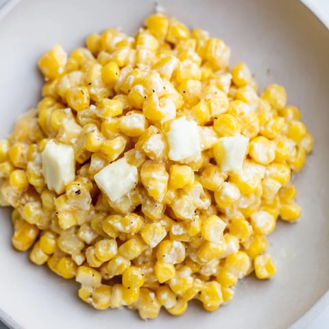 Golden skillet of Honey Butter Corn, glistening with melted butter and sweet honey, ready to serve.