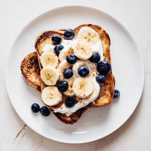 Golden-brown Protein French Toast, topped with fresh berries, promises a delicious, high-protein breakfast.