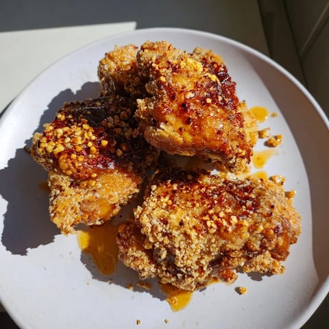 Golden, crispy Hot Honey Crispy Chicken Thighs glistening with a spicy honey glaze, ready to serve.