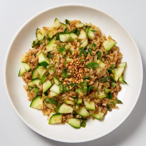 Vibrant Crispy Cucumber Rice Salad features crunchy cucumber and fluffy rice, drizzled with sesame-soy dressing.
