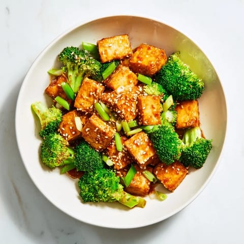Crispy sesame tofu and roasted broccoli, glistening with a savory glaze, perfect sheet pan meal.