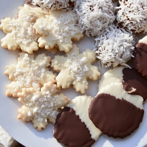 Visually stunning snowflake dessert board, brimming with colorful berries and delicious cookies.