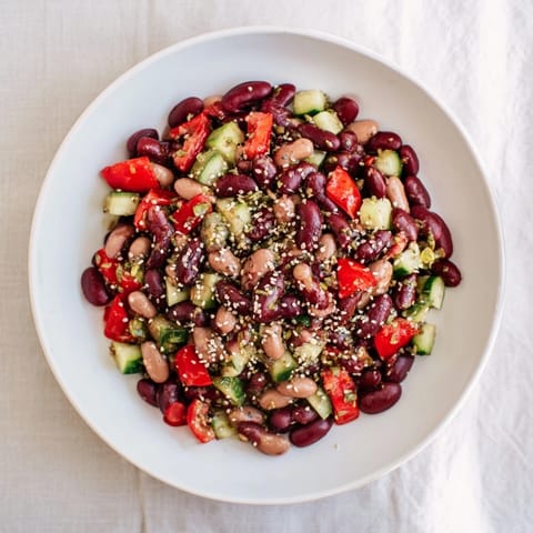 Freshly tossed Dense Bean Salad with visible chia and hemp seeds, ready to serve and enjoy.