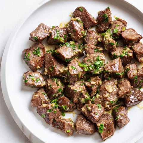Picture perfect air-fryer garlic-butter steak bites, deliciously tender and coated in a garlic-infused butter glaze.