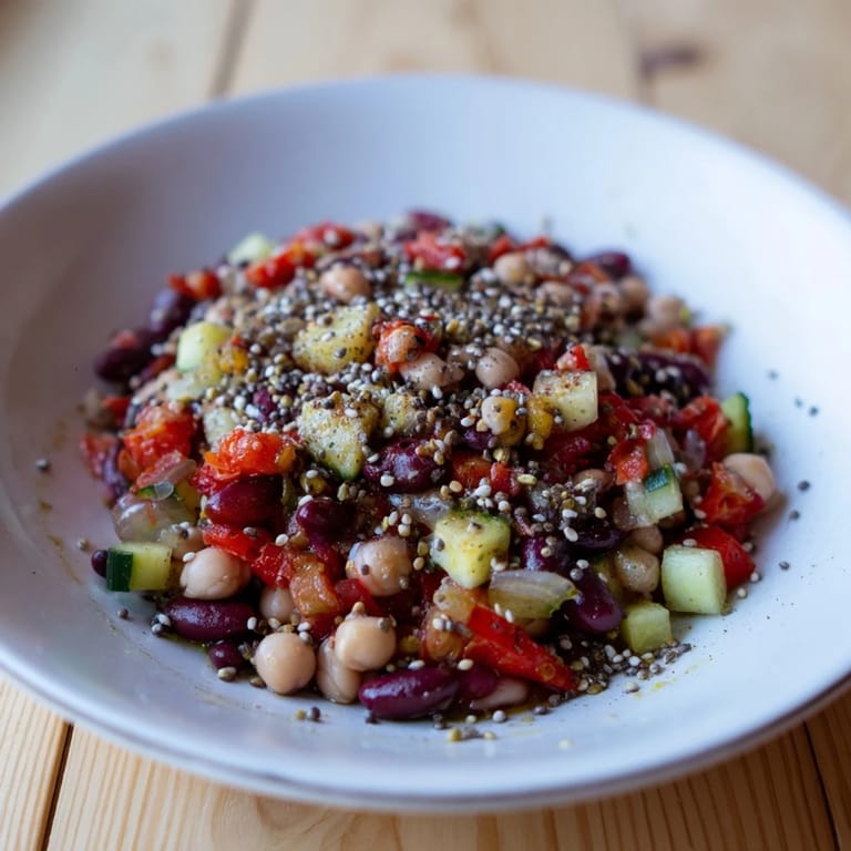 A close-up shot of the healthy Dense Bean Salad with beans, vegetables, and a zesty dressing.