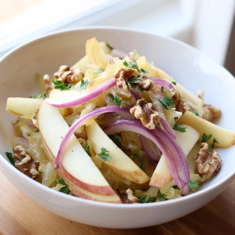 A close-up of Warm Apple and Sauerkraut Skillet Salad, highlighting juicy apples and tangy probiotic sauerkraut.