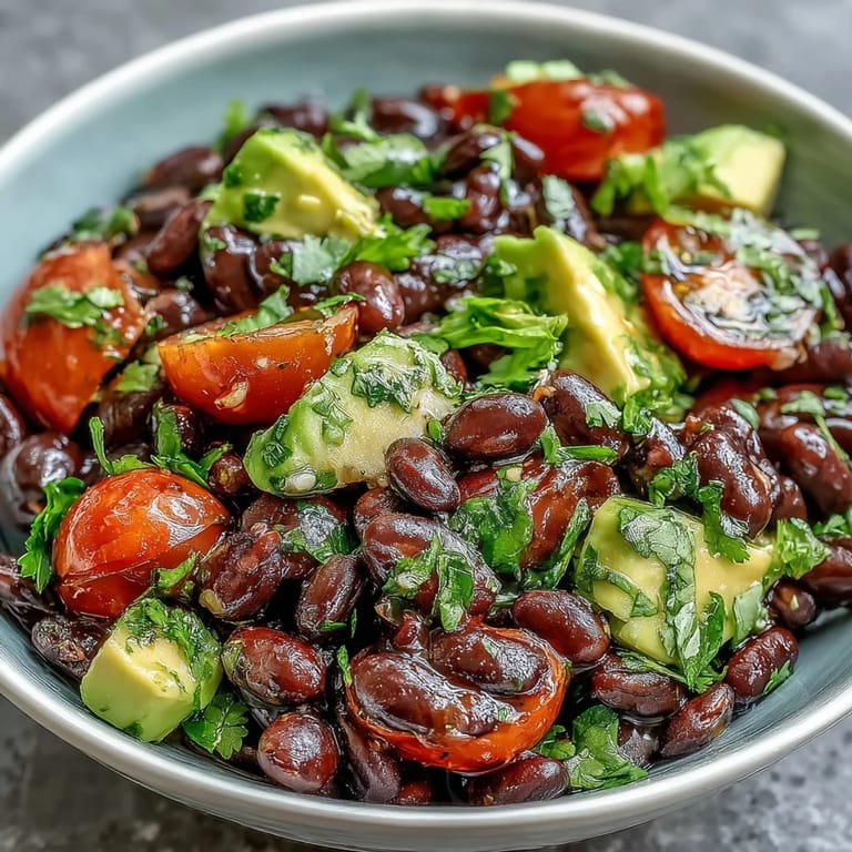 Nutritious Black Bean and Veggie Bowl featuring creamy avocado and crisp red onion, a perfect vegan main dish.