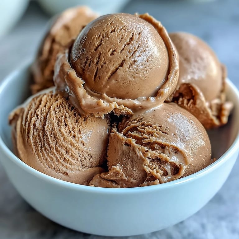 Richly colored roasted green tea Hojicha Ice Cream in a ceramic dish, close-up.