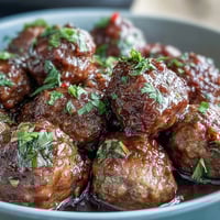 Slow cooker Mississippi meatballs with pepperoncini and ranch seasoning, cooked until tender and flavorful.  