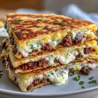 Crispy shepherds pie quesadillas filled with savory meat, veggies, and creamy mashed potatoes, pan-fried to golden perfection.
