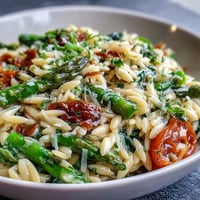 Spring Orzo Primavera with asparagus, peas, and parmesan in a vibrant vegetable pasta dish.  
